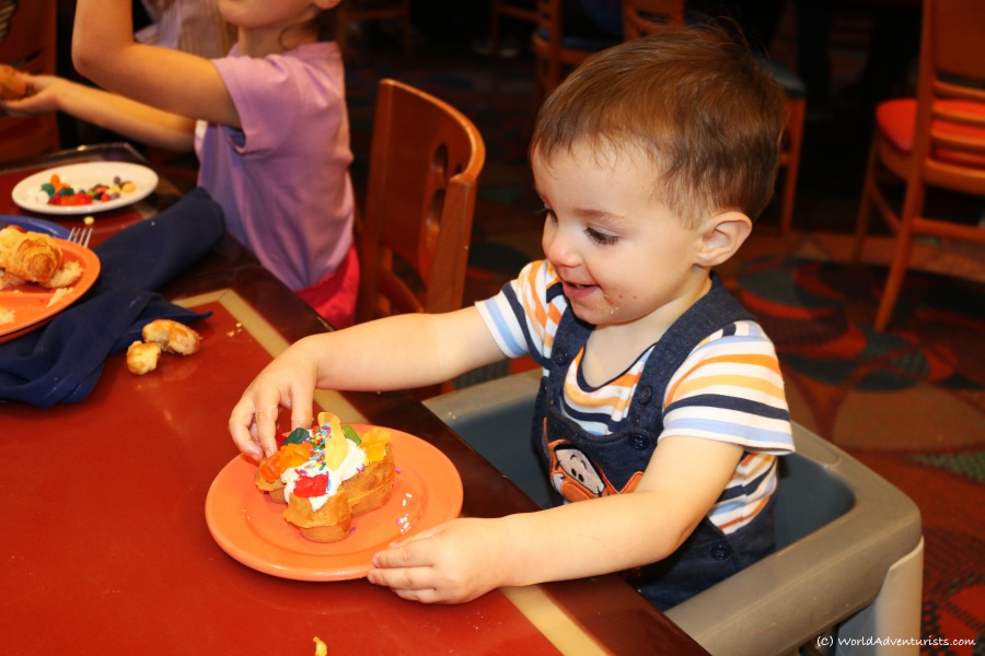 Little boy enjoying dessert at Chef Mickey's