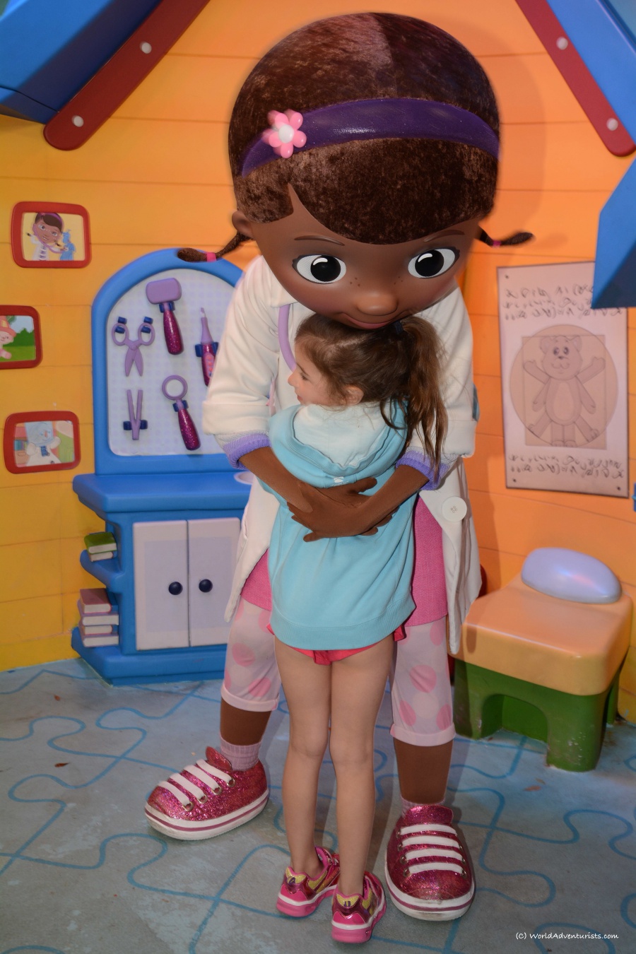 Doc McStuffins hugging a little girl 