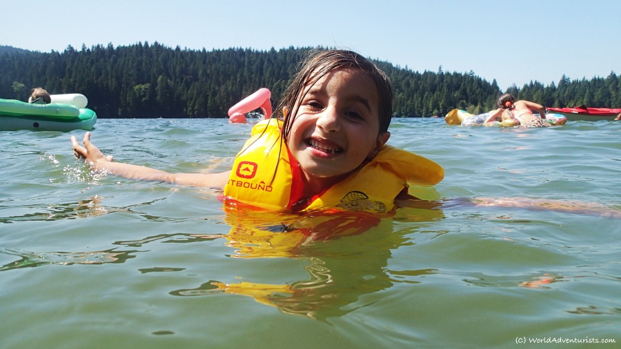  a smiling girl swimming at sasamat lake 