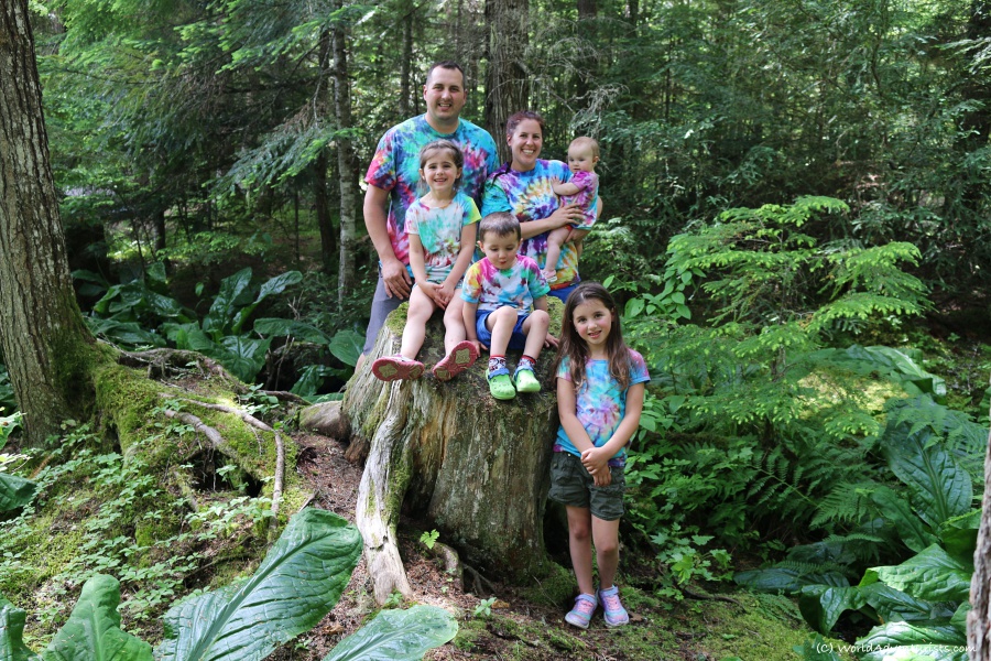 Family smiling in tie dye shirts at Birkenhead Lake in Pemberton, BC